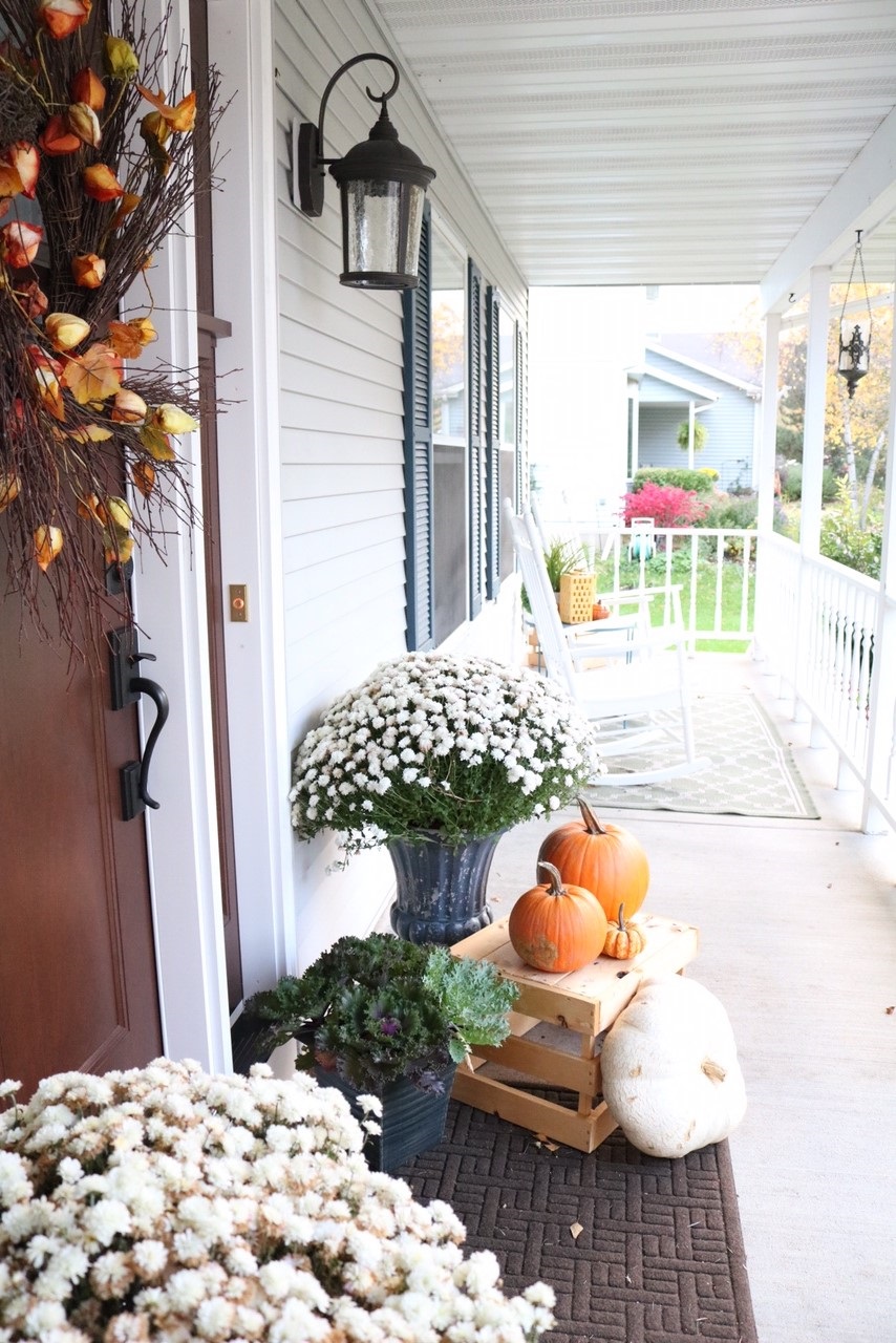 Fall Front Porch Inspiration | Pumpkins, door wreath with branches, kale planters, apple crates, mums, and cornstalks!